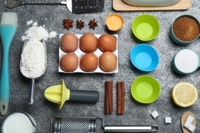 Cooking utensils and ingredients on grey table, flat lay