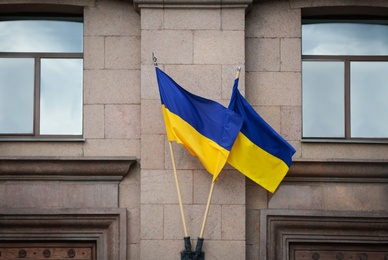 Photo of National flags of Ukraine on building facade