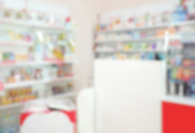 Blurred view of shelves with pharmaceuticals in modern drugstore