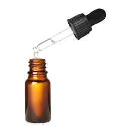 Bottle and pipette with essential oil on white background