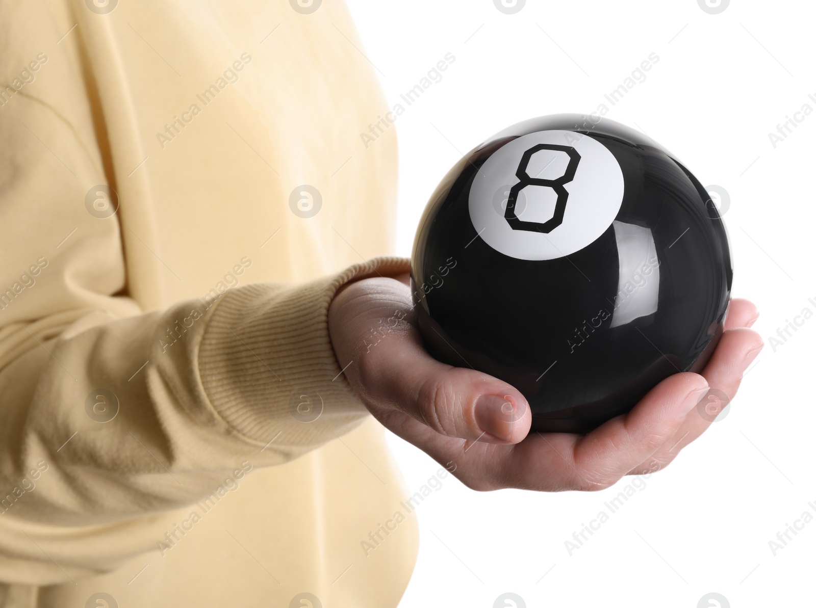 Photo of Woman holding magic eight ball on white background, closeup