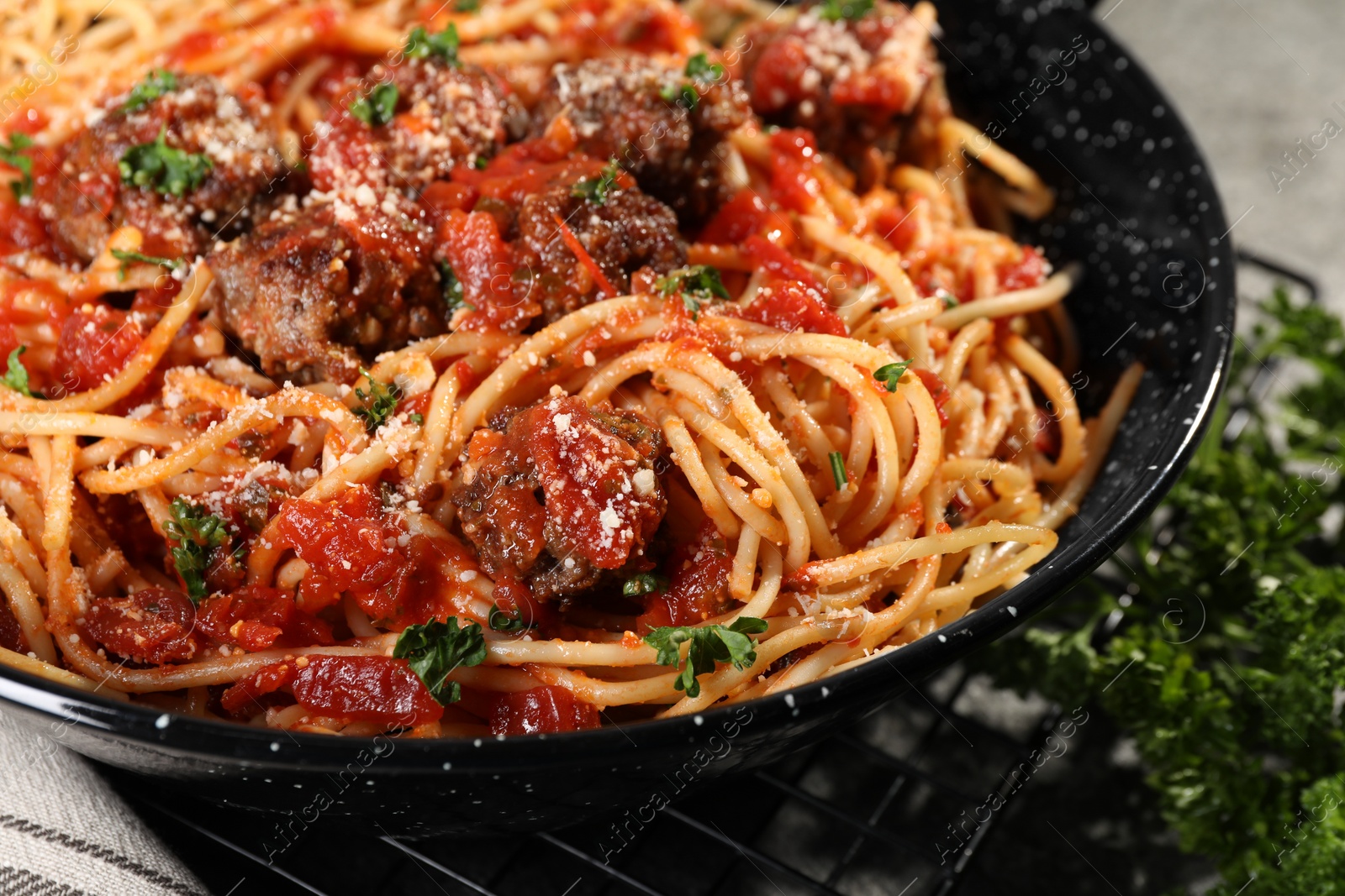 Photo of Delicious pasta with meatballs and tomato sauce on frying pan, closeup