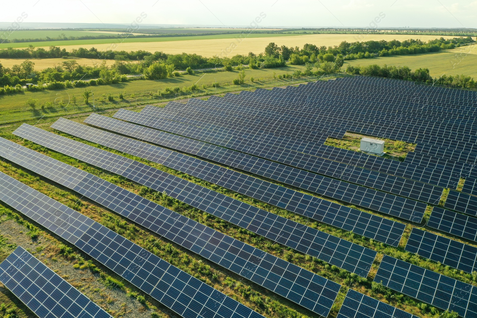 Photo of Solar panels installed outdoors, aerial view. Alternative energy source