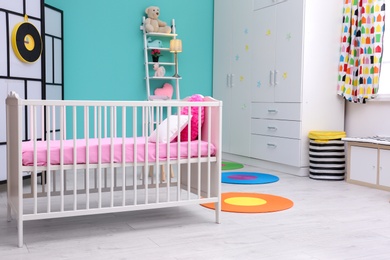 Photo of Light baby room interior with crib