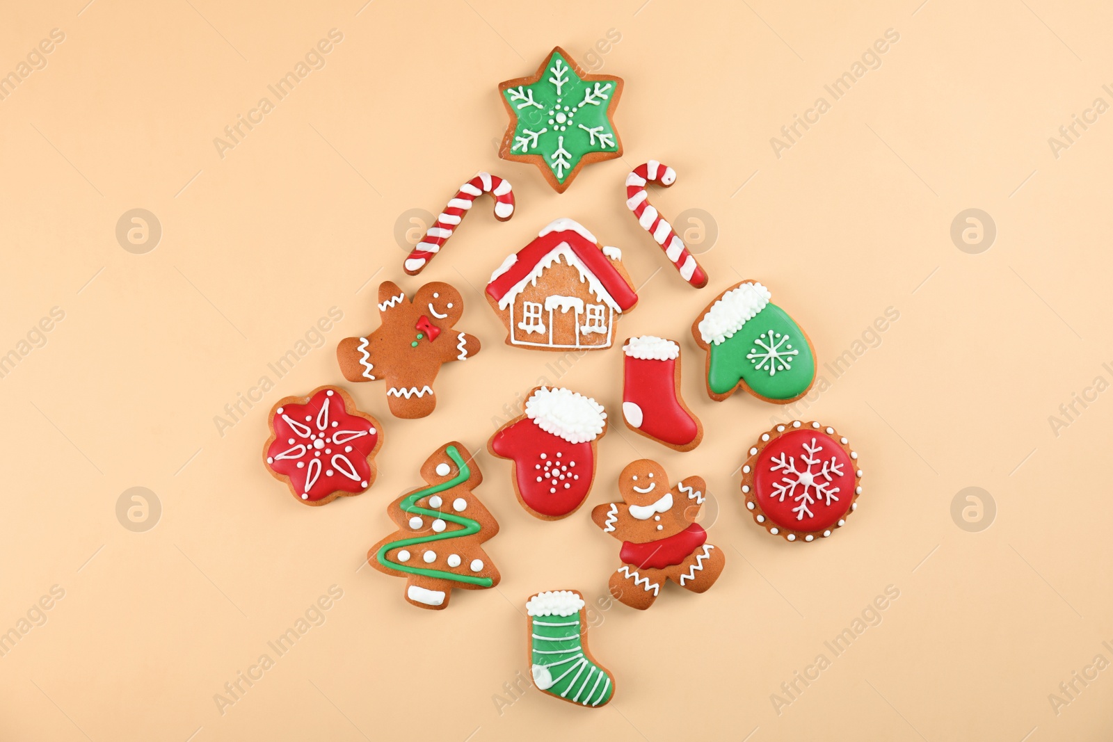 Photo of Christmas tree shape made of tasty homemade cookies on color background, top view