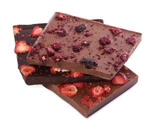 Halves of chocolate bars with freeze dried berries on white background