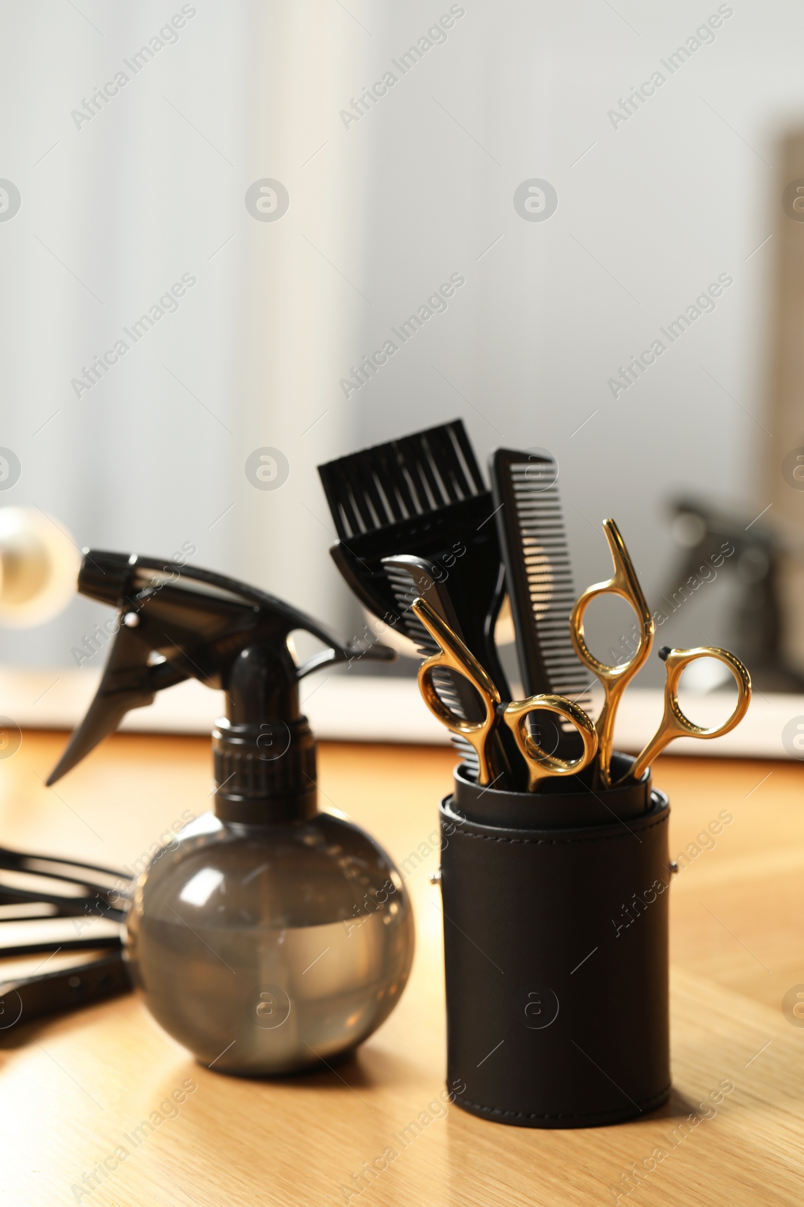 Photo of Set of hairdresser tools on table in salon