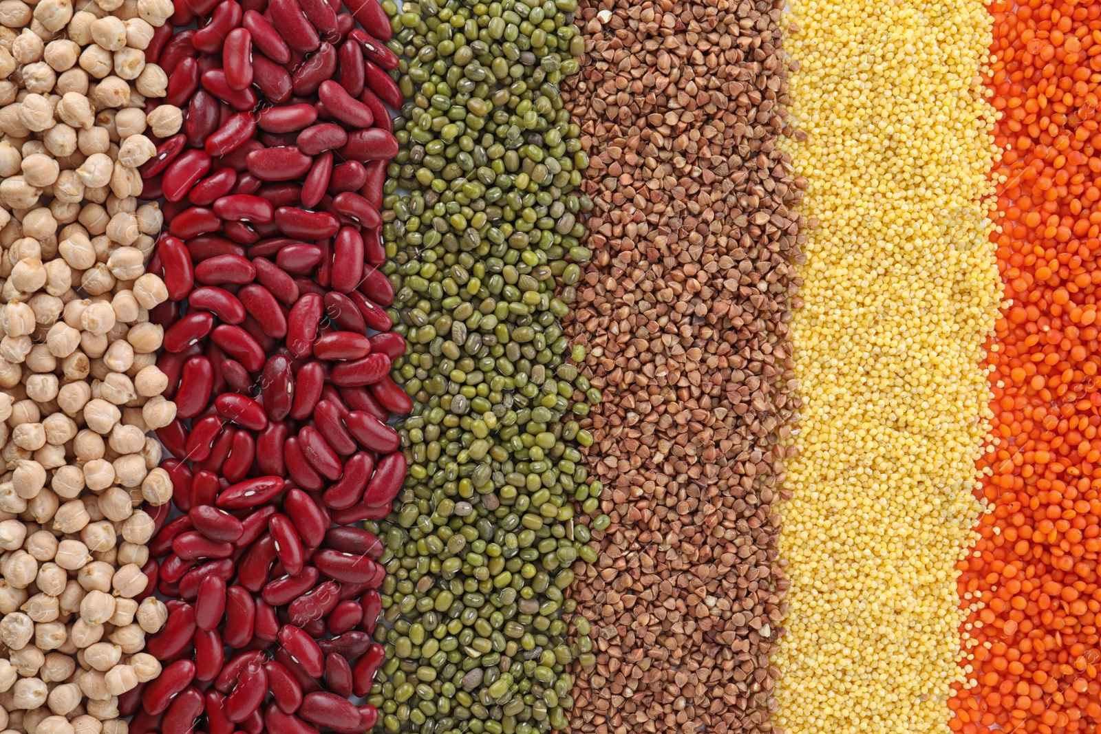 Photo of Different grains and cereals as background, top view