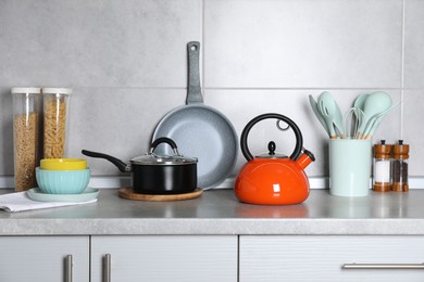 Photo of Cooking utensils and other kitchenware on grey countertop