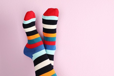 Photo of Woman wearing stylish socks and space for design on color background