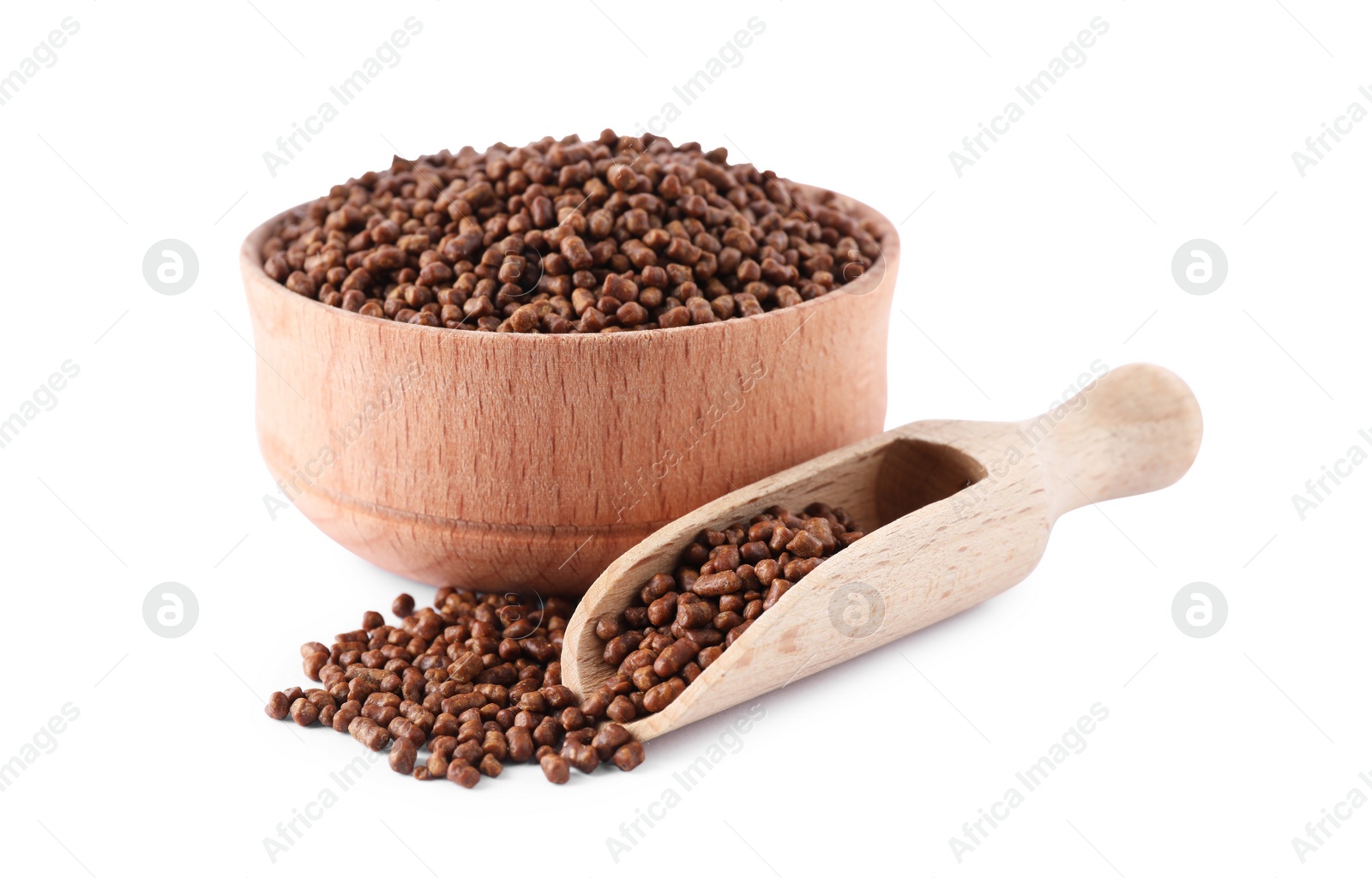 Photo of Wooden bowl and scoop with buckwheat tea granules white background
