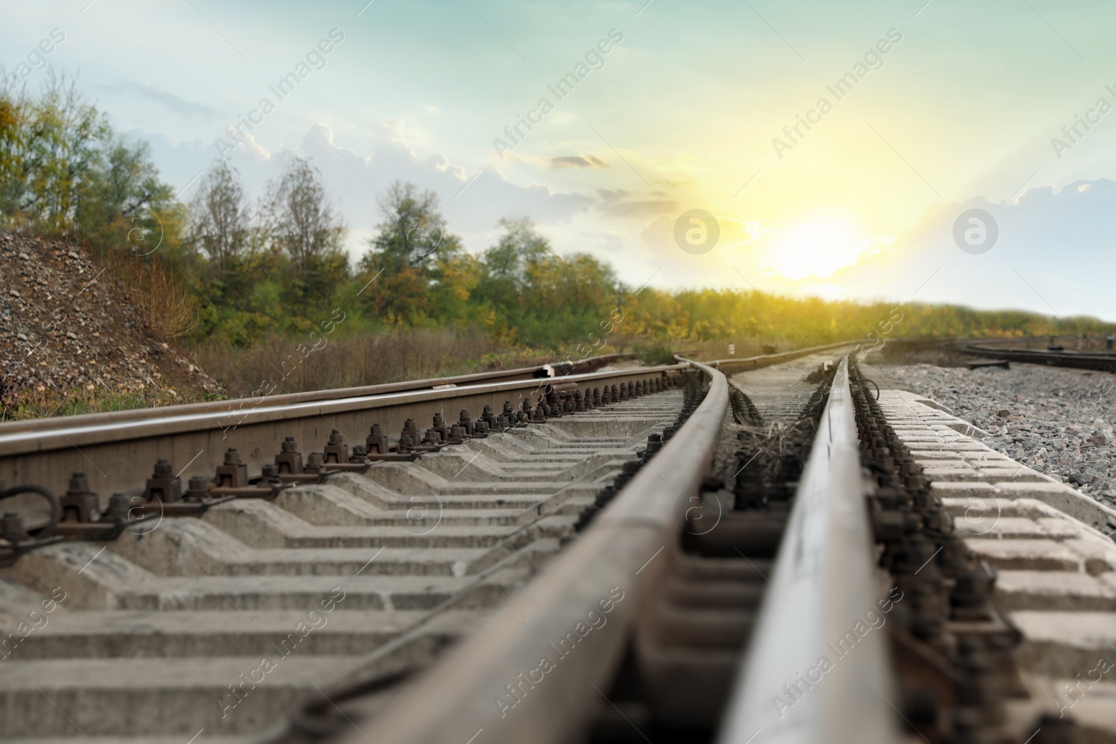 Photo of Railway lines with track ballast in countryside, closeup. Train journey