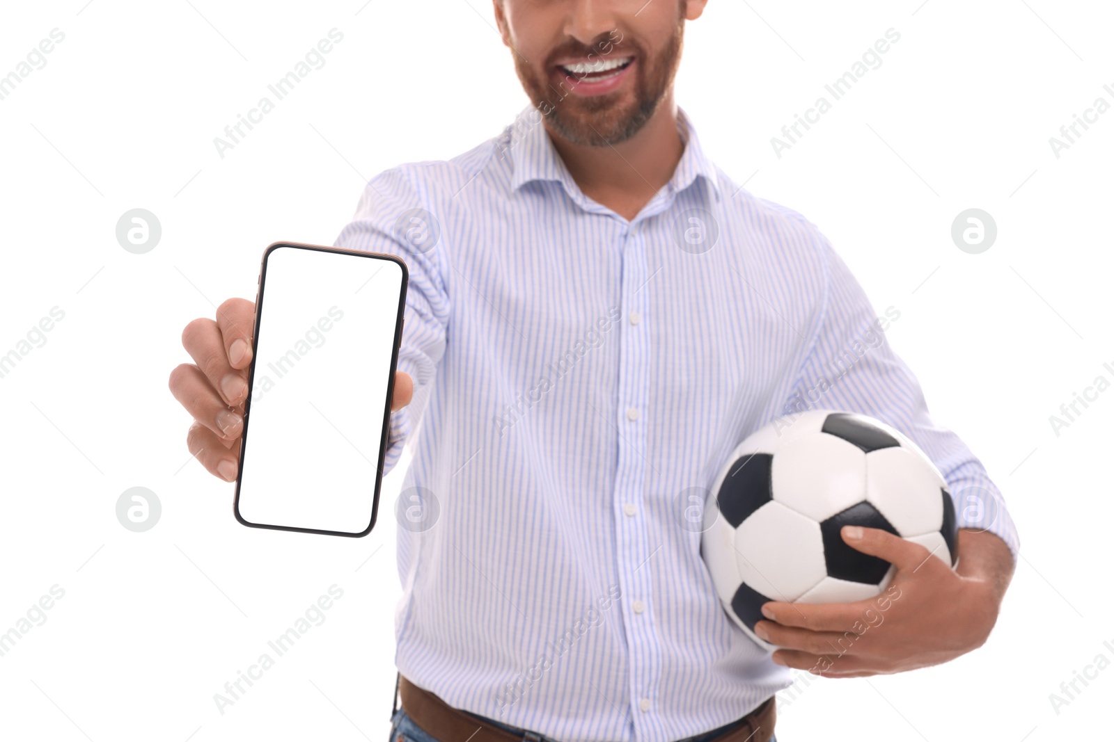 Photo of Happy sports fan with soccer ball and smartphone on white background, closeup