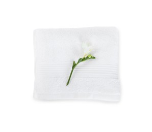 Photo of Terry towel and freesia flower isolated on white, top view