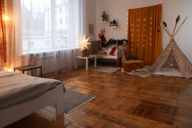 Cozy bedroom with stylish Christmas decor. Interior design