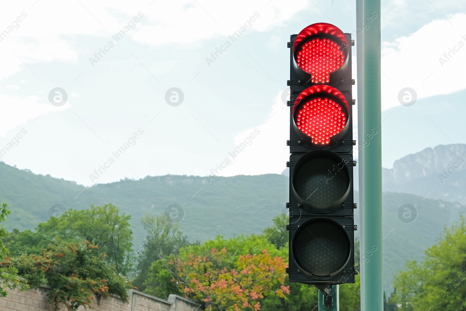 Photo of Traffic lights and beautiful mountains on background, space for text