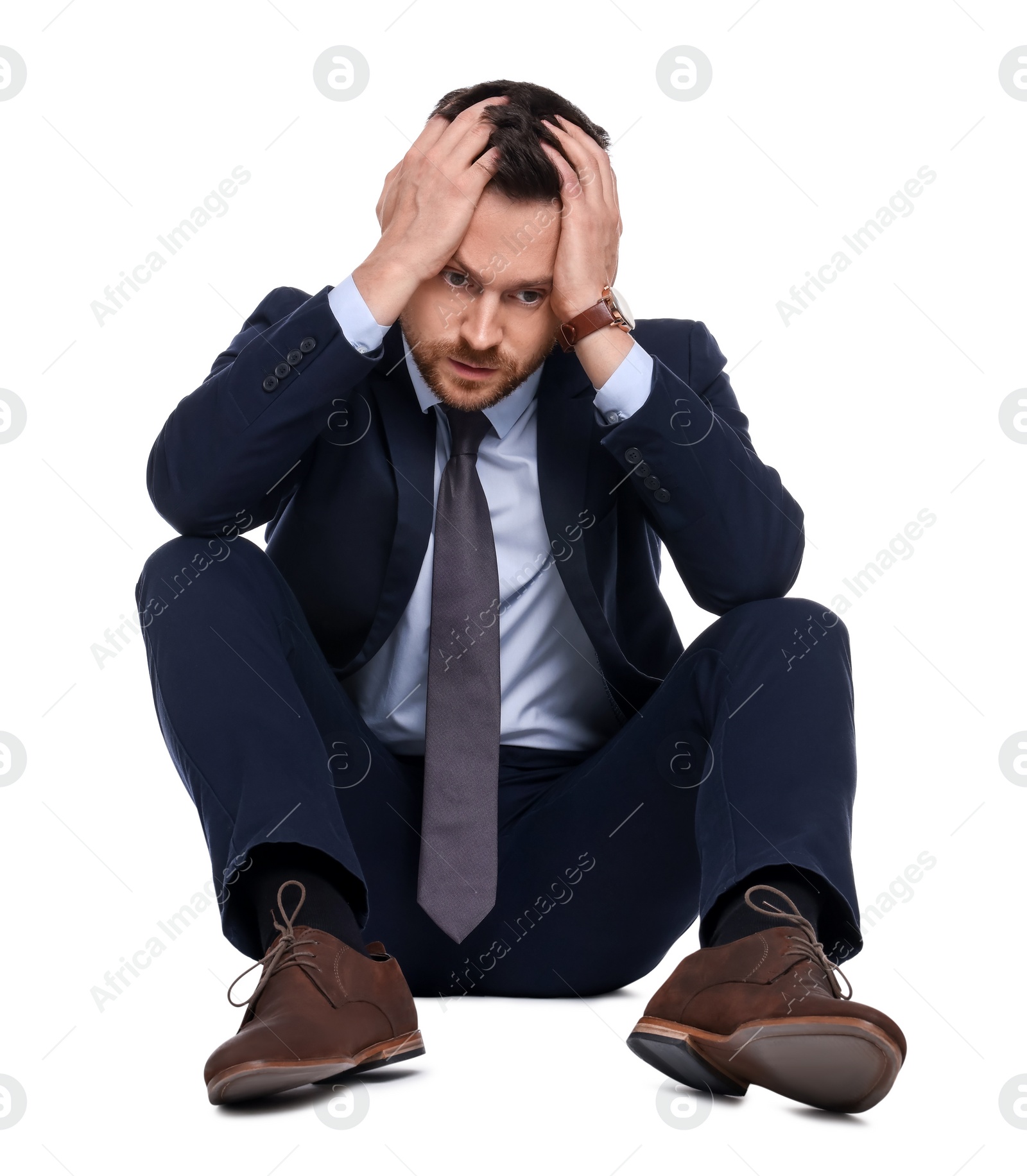 Photo of Upset bearded businessman in suit on white background