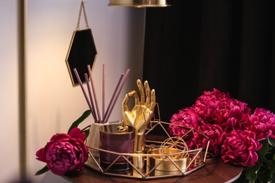 Photo of Composition with stylish accessories, flowers and interior elements on table indoors