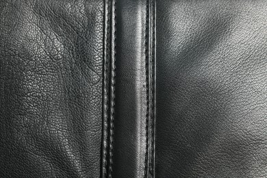 Photo of Black natural leather with seams as background, top view