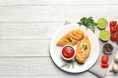 Photo of Flat lay composition with fried chicken breasts and space for text on wooden background