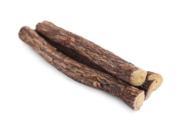 Dried sticks of liquorice root on white background