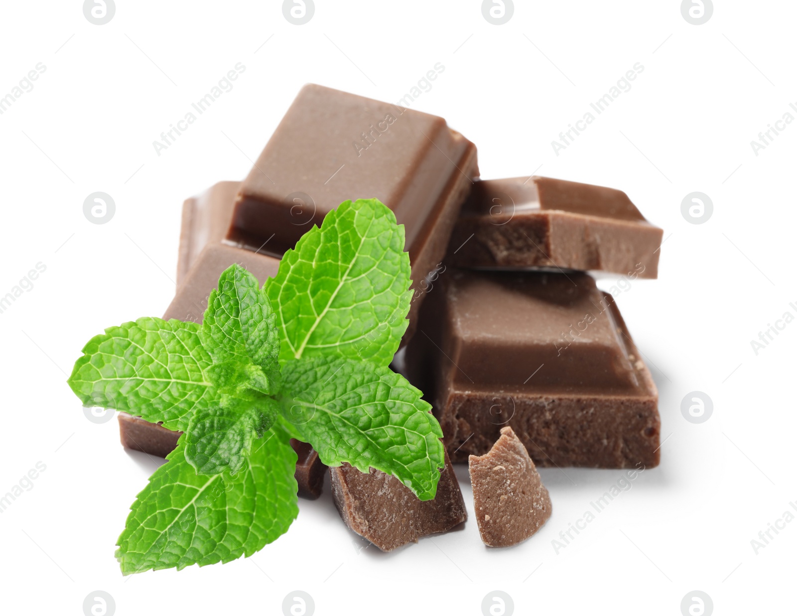 Image of Tasty milk chocolate pieces and mint on white background