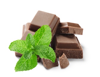 Image of Tasty milk chocolate pieces and mint on white background