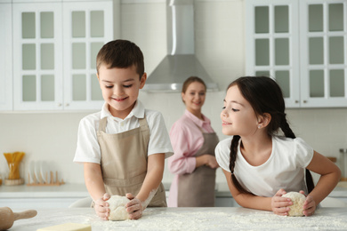 Happy family cooking together in kitchen at home