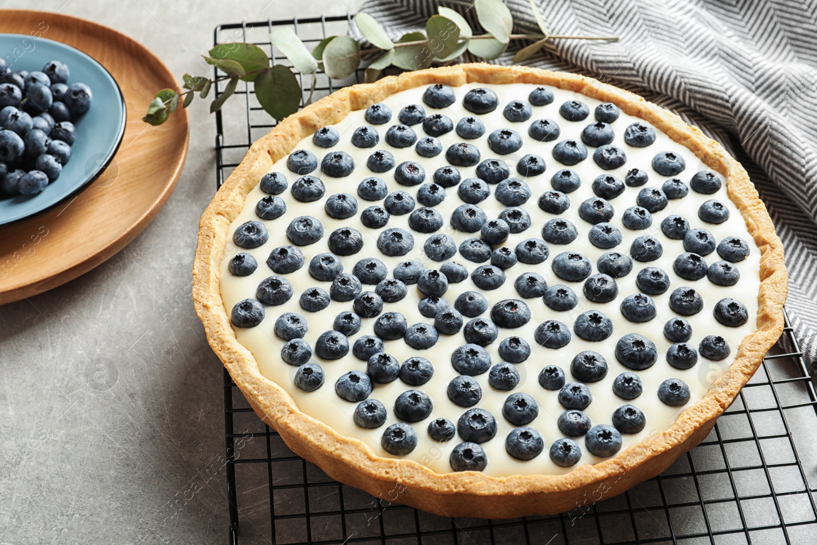 Photo of Tasty cake with blueberry on gray table