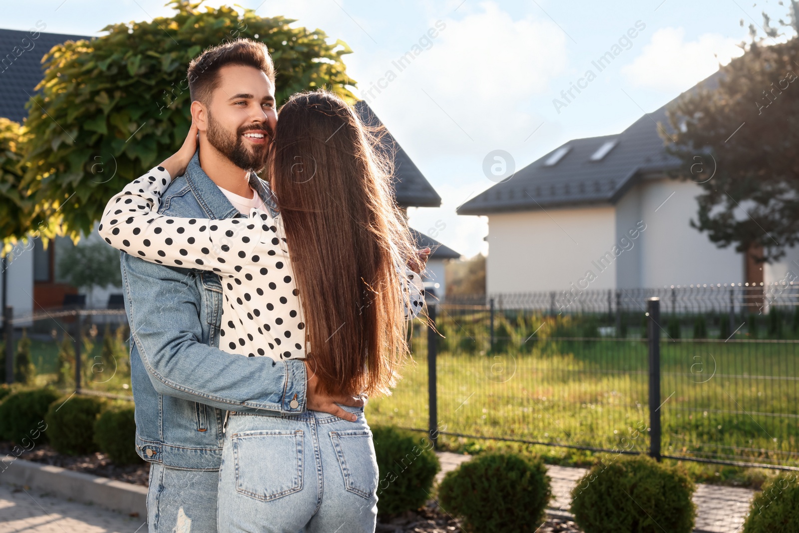 Photo of Happy couple dancing outdoors on sunny day. Space for text