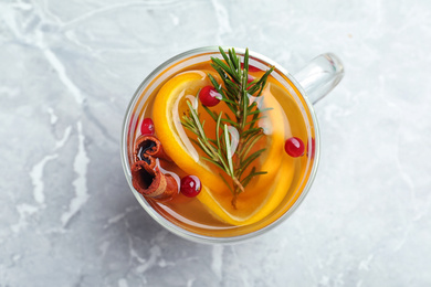 Aromatic mulled wine on grey marble table, top view