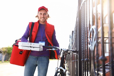 Male courier delivering food in city on sunny day