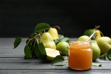 Delicious pear jam and fresh fruits on grey wooden table