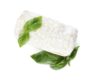 Photo of Delicious fresh goat cheese with basil on white, top view
