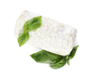 Delicious fresh goat cheese with basil on white, top view