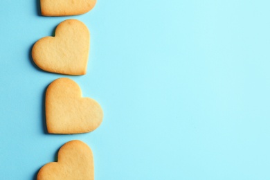 Photo of Homemade heart shaped cookies and space for text on color background, top view