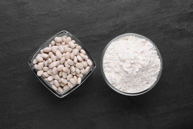 Bean flour and seeds on black table, flat lay