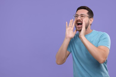 Photo of Special promotion. Man shouting to announce information on purple background. Space for text