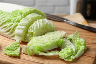 Photo of Cut fresh Chinese cabbage on wooden board, closeup