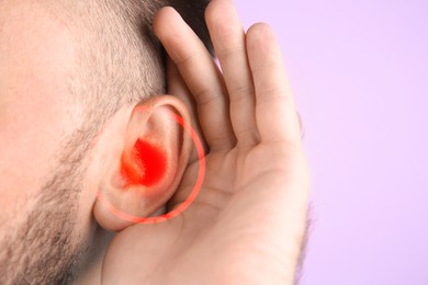 Image of Man suffering from earache on pink background, closeup 