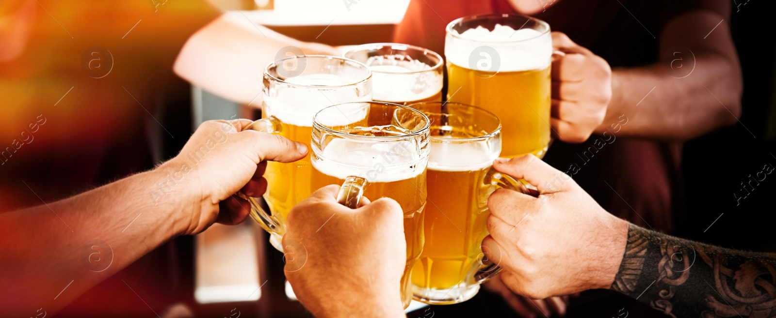 Image of Group of friends toasting with beer in pub, closeup. Banner design