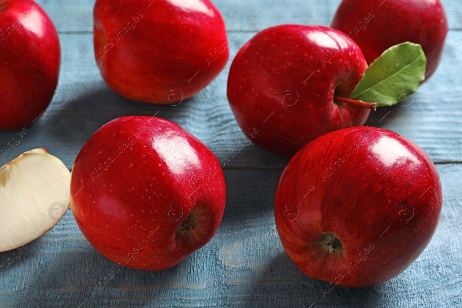 Photo of Ripe red apples on wooden background