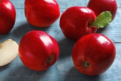 Photo of Ripe red apples on wooden background