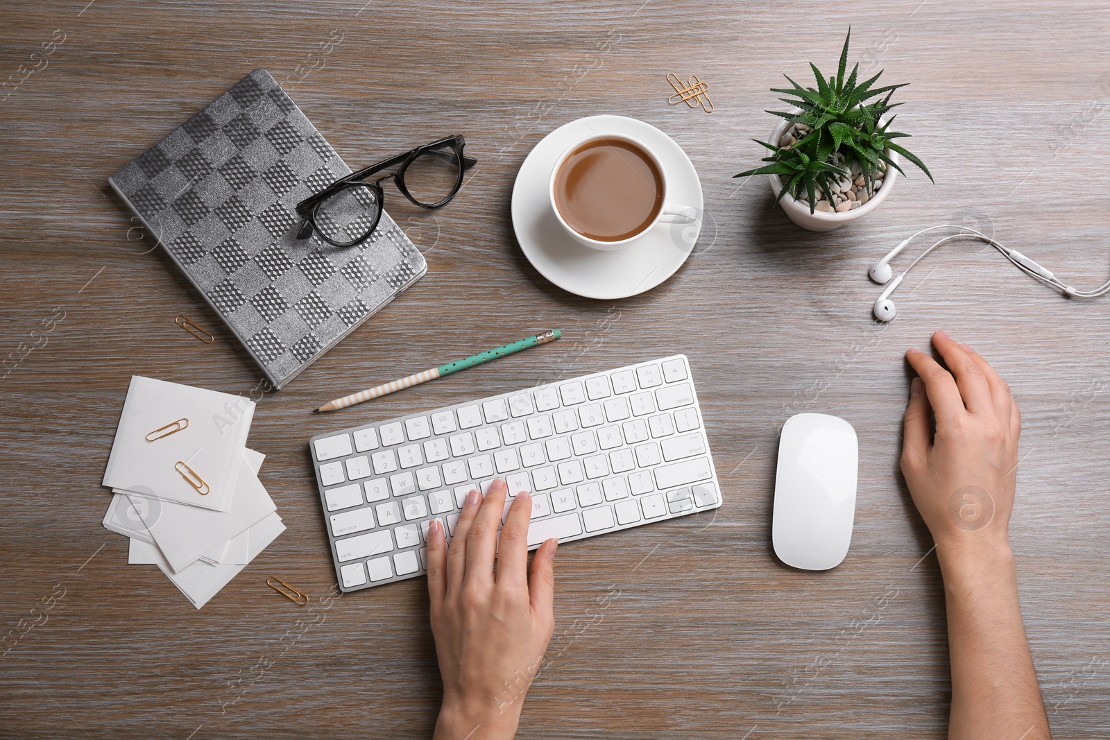 Photo of Woman using computer mouse and keyboard at office table, top view