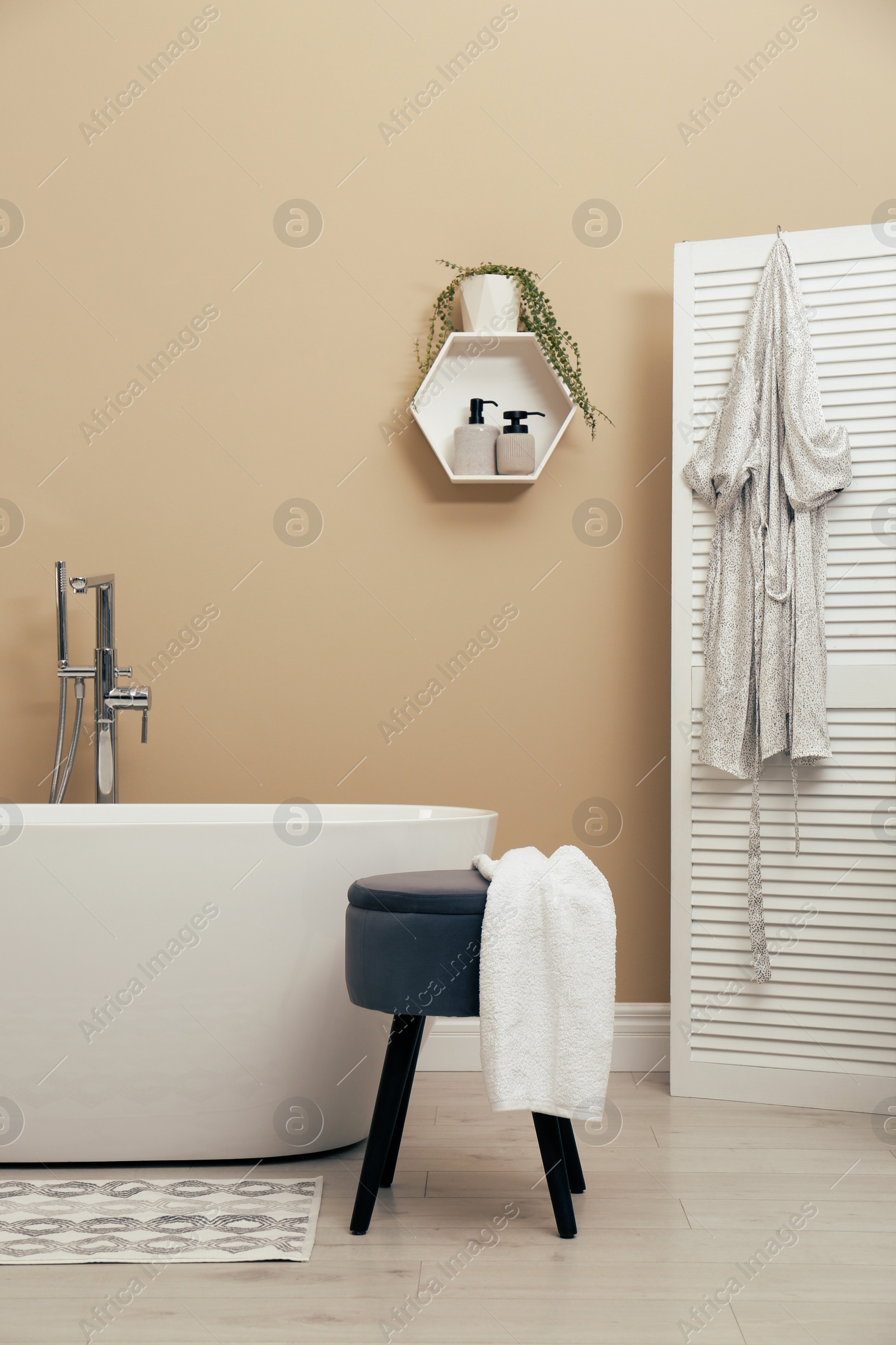 Photo of Cozy bathroom interior with stylish ceramic tub