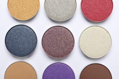 Beautiful eye shadow refill pans on white background, flat lay