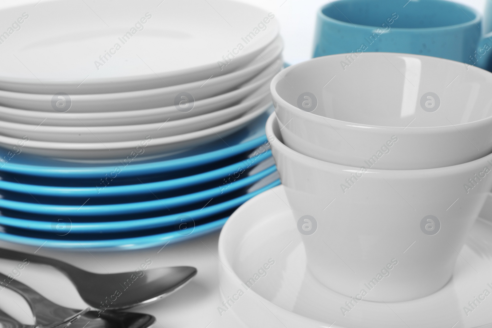 Photo of Set of clean tableware on white background, closeup. Washing dishes