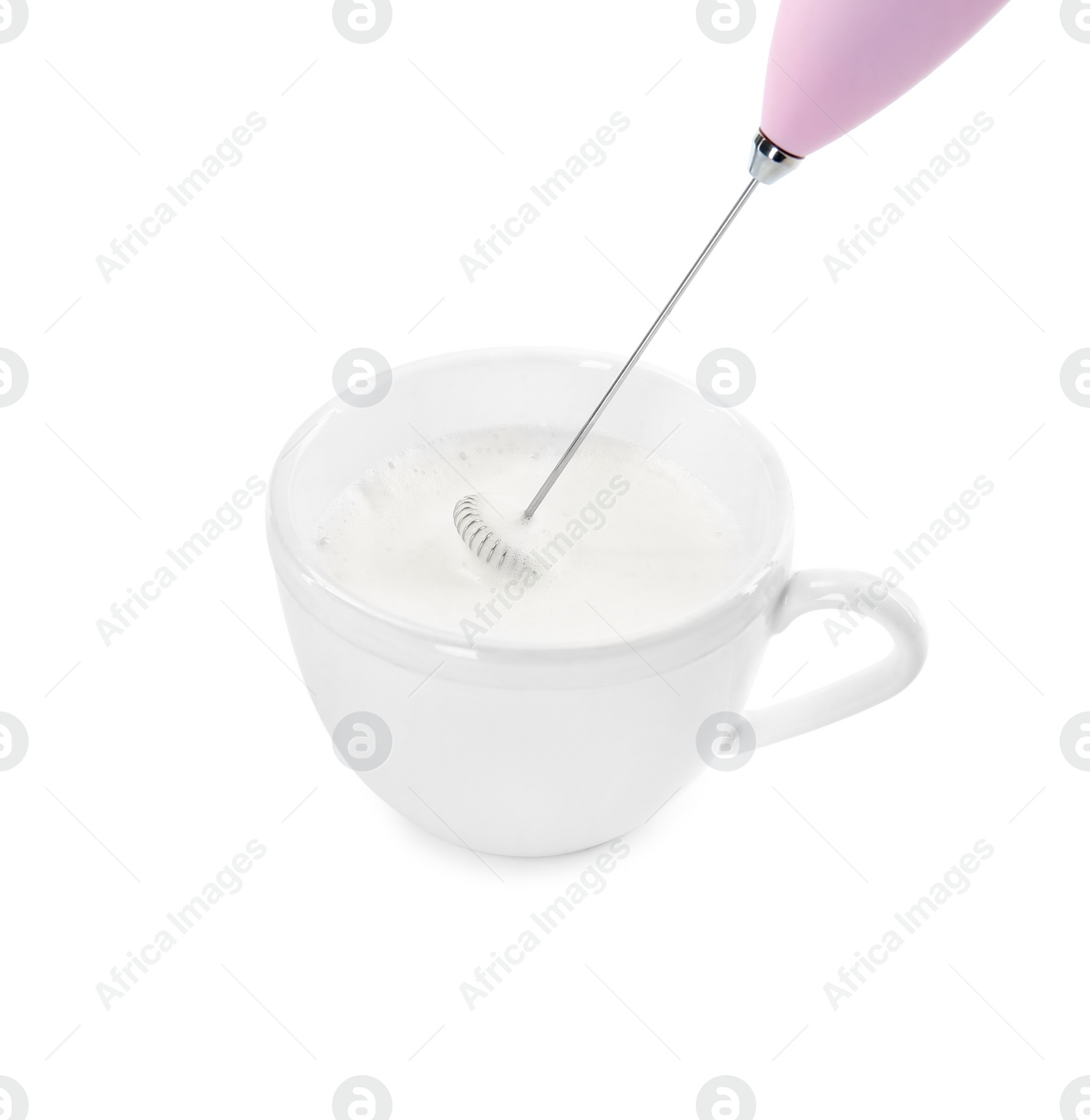 Photo of Whisking milk in cup with mini mixer (frother wand) isolated on white