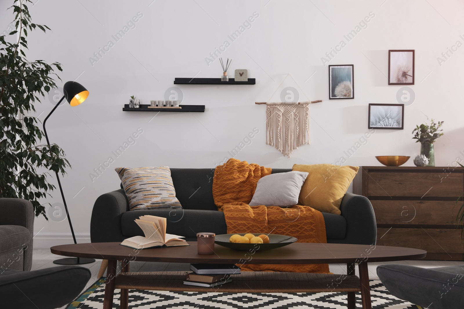 Photo of Stylish living room interior with comfortable sofa and wooden table