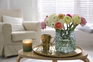 Photo of Beautiful ranunculus flowers in vase on wooden table indoors, space for text